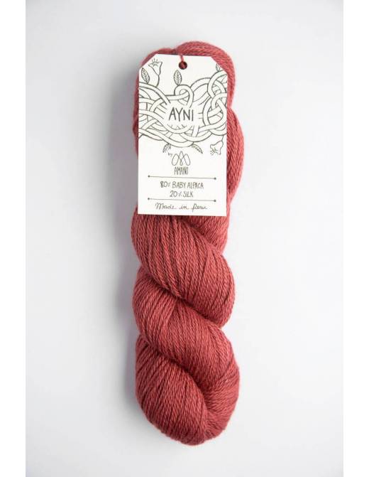 Red skein of yarn with a label on a white background