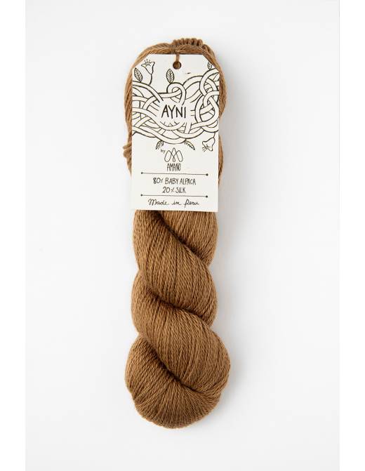 Brown skein of yarn with a label on a white background