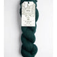 Dark green skein of yarn with a 'Ayni' label on a white background