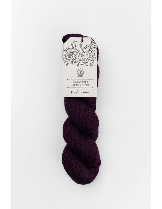 Purple skein of yarn with a label on a white background