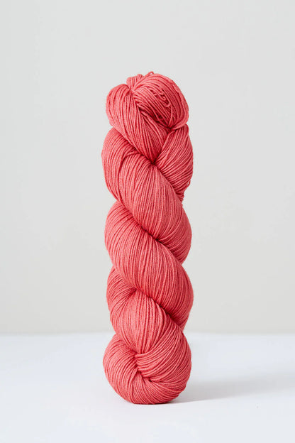 A skein of salmon pink superwash merino wool from Urth 