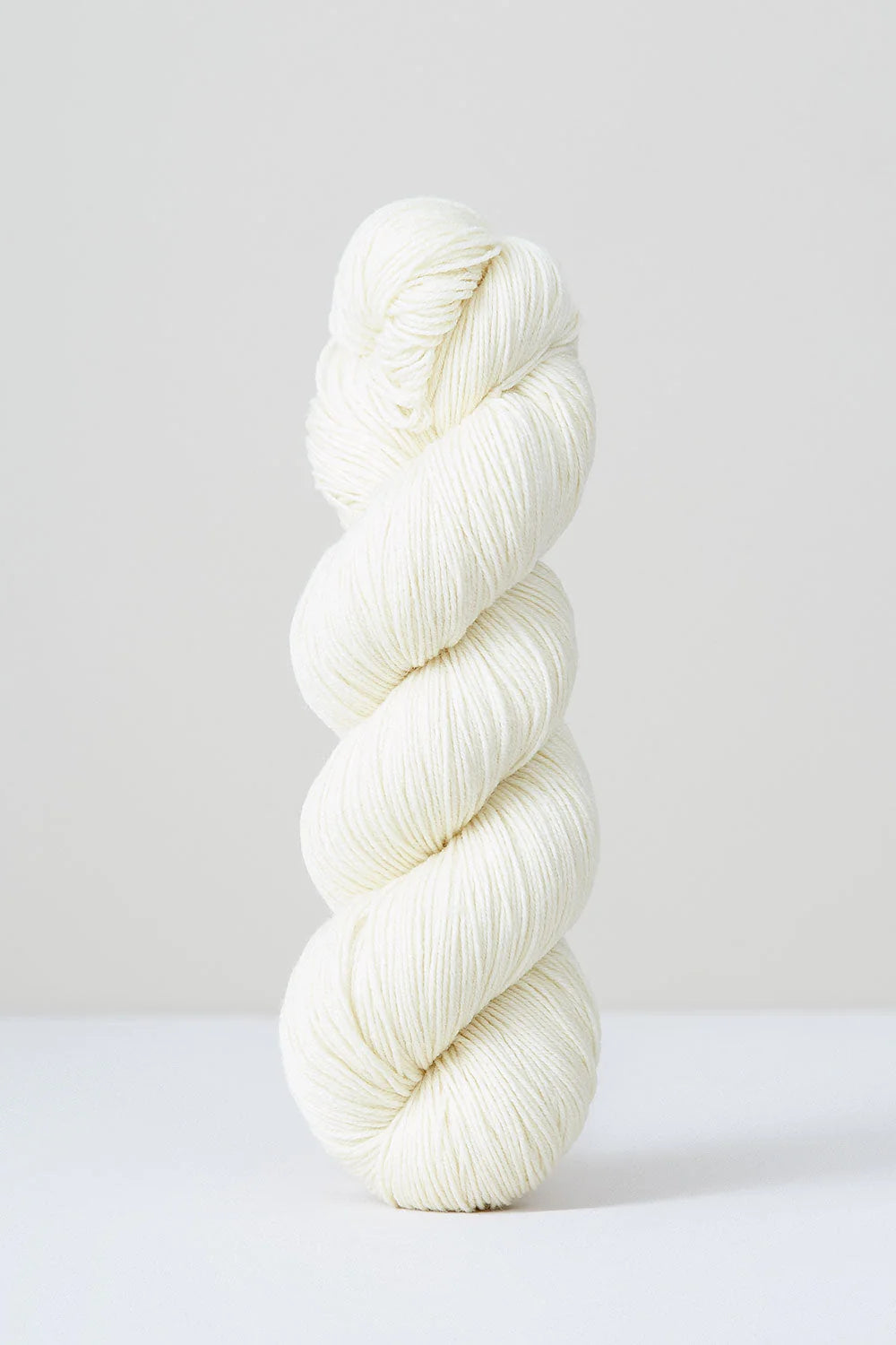 A skein of white superwash merino wool from Urth 