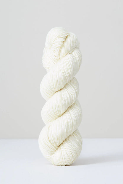 A skein of white superwash merino wool from Urth 