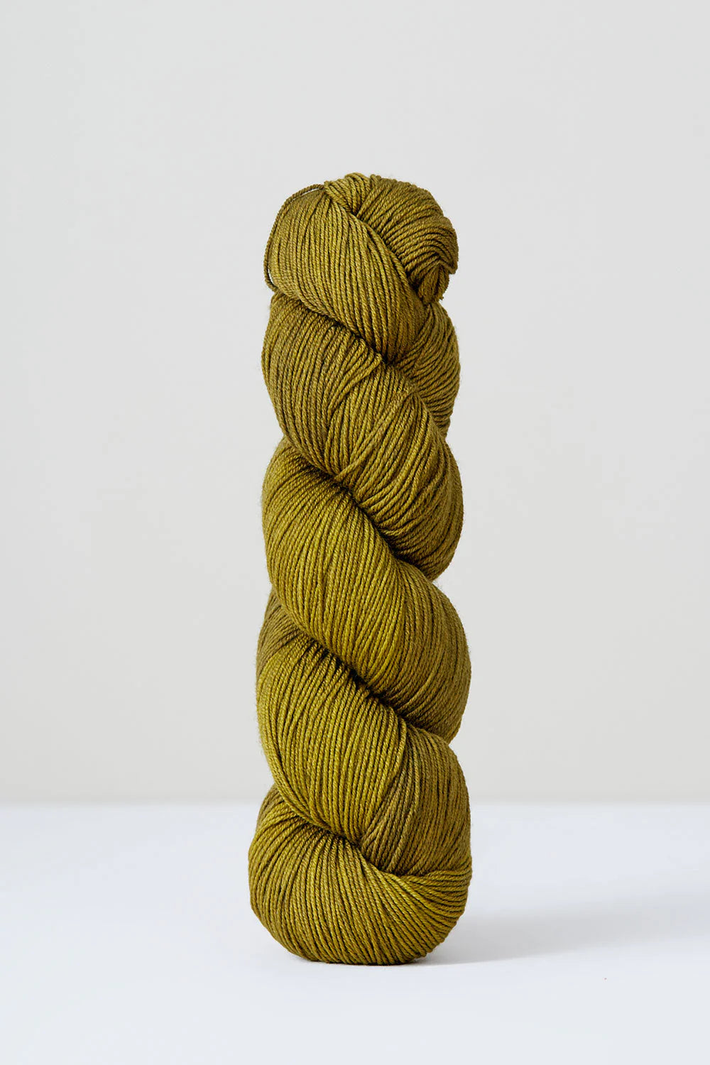 A skein of yellow/green superwash merino wool from Urth 