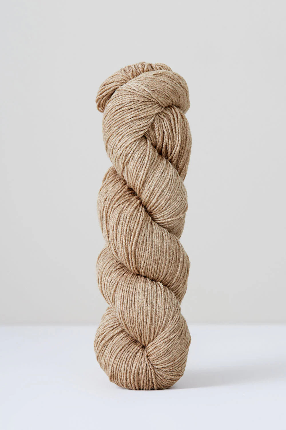 A skein of pale beige superwash merino wool from Urth 