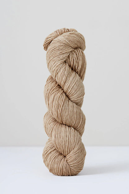 A skein of pale beige superwash merino wool from Urth 