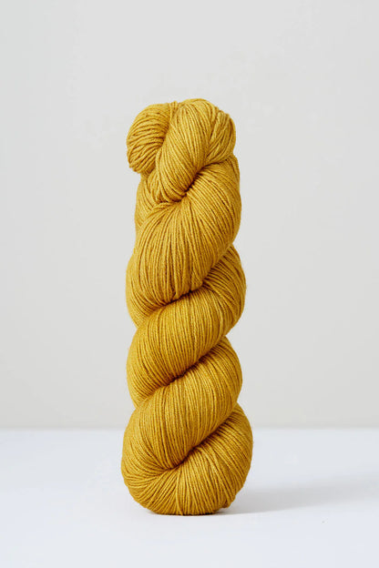A skein of golden yellow superwash merino wool from Urth 