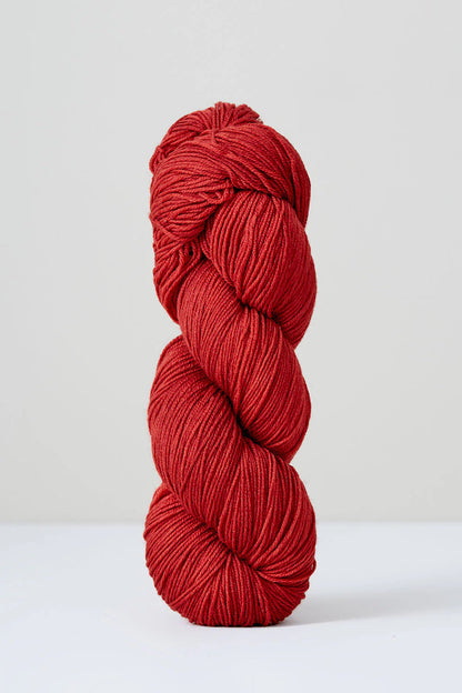 A skein of red superwash merino wool from Urth 