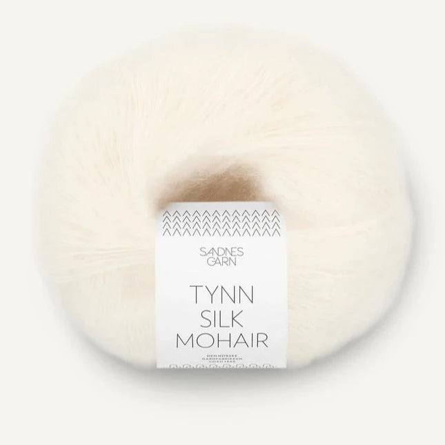 A ball of Tynn Silk Mohair yarn in a  white color with a 'Tynn Silk Mohair' label from Sandnes Garn