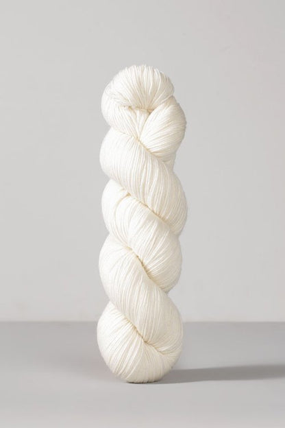 White skein of merino and nylon yarn from Urth
