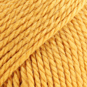 Close-up of golden wool and alpaca yarn from Drops