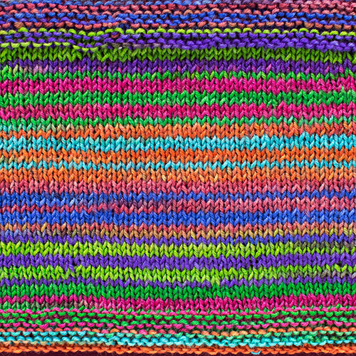 a knitted swatch of merino yarn with blue, purple, pink, orange, and green tones from Urth yarns