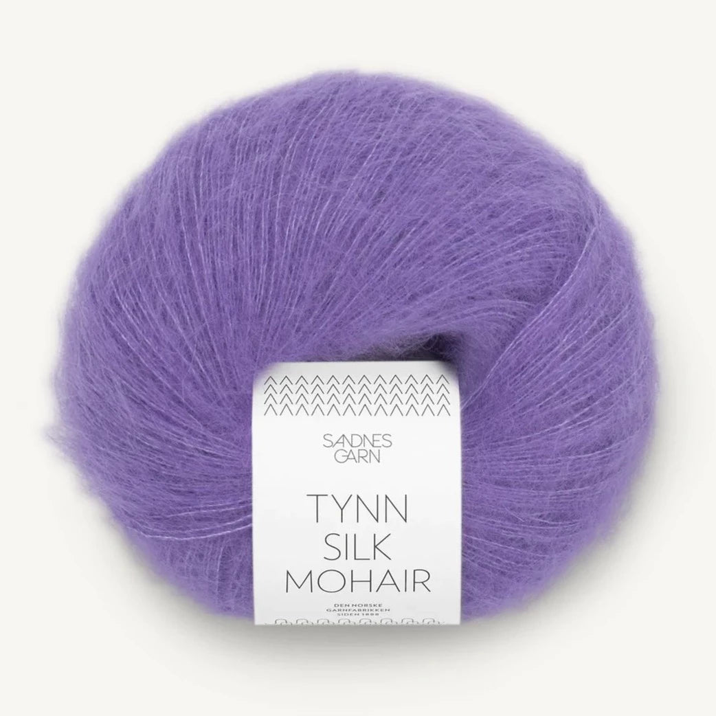 A ball of Tynn Silk Mohair yarn in a purple color with a 'Tynn Silk Mohair' label from Sandnes Garn