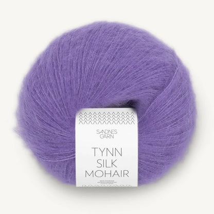 A ball of Tynn Silk Mohair yarn in a purple color with a 'Tynn Silk Mohair' label from Sandnes Garn