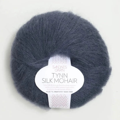 A ball of Tynn Silk Mohair yarn in a grey-blue color with a 'Tynn Silk Mohair' label from Sandnes Garn