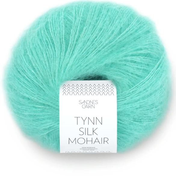 A ball of Tynn Silk Mohair yarn in a teal turquoise color with a 'Tynn Silk Mohair' label from Sandnes Garn