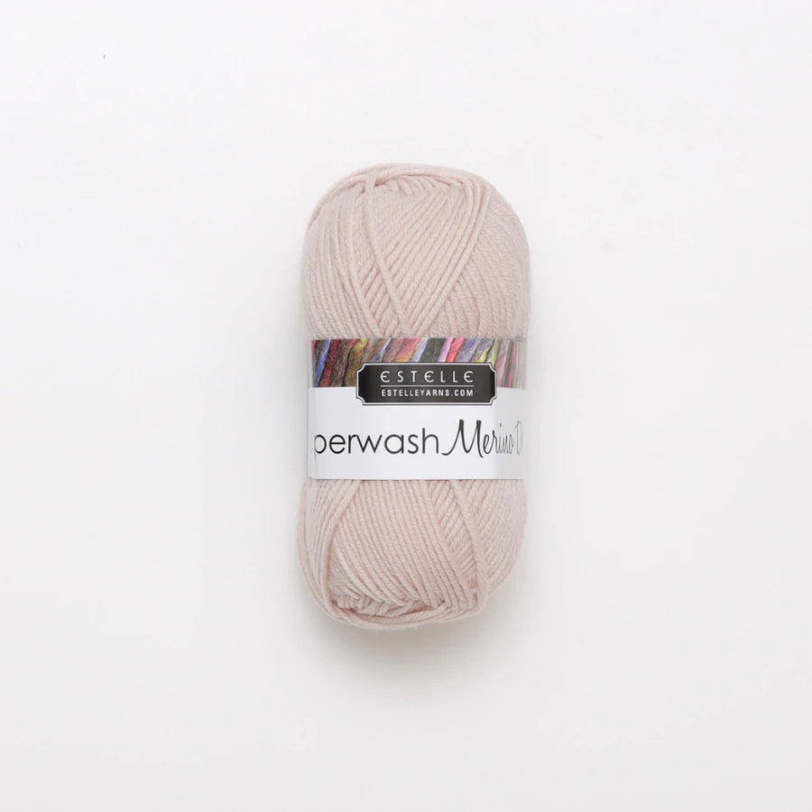 A skein of light pink Superwash merino wool DK yarn labeled 'Superwash Merino DK' by 'Estelle'.