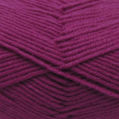 A skein of Estelle Superwash Merino DK  wool yarn in Magenta pink colour.