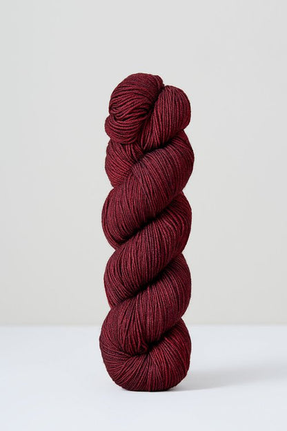 A skein of deep red superwash merino wool from Urth 