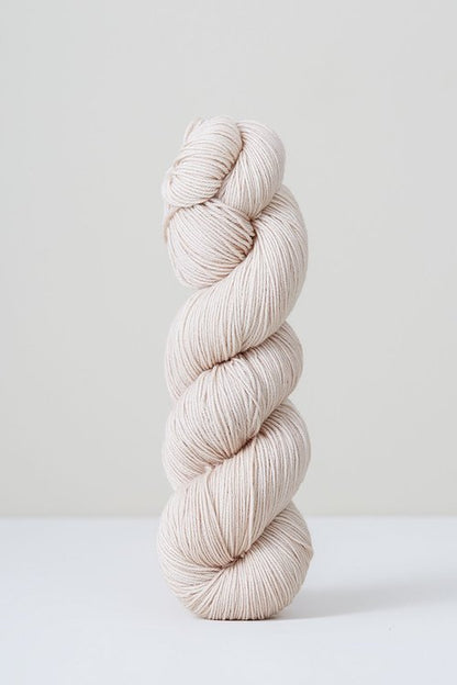 A skein of beige/white superwash merino wool from Urth 