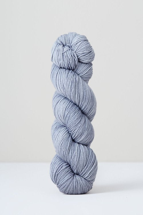 A skein of pale grey/purple superwash merino wool from Urth 